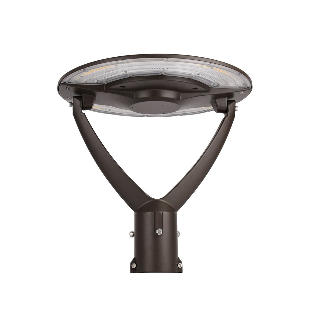 The photo shows a bronze LED post top light with a PC lens. It has selectable power and color temperature, operates on 100-277VAC with Type V distribution and THD<15%, and is made of aluminum alloy. The light is designed to fit a 3-inch pole mount.
